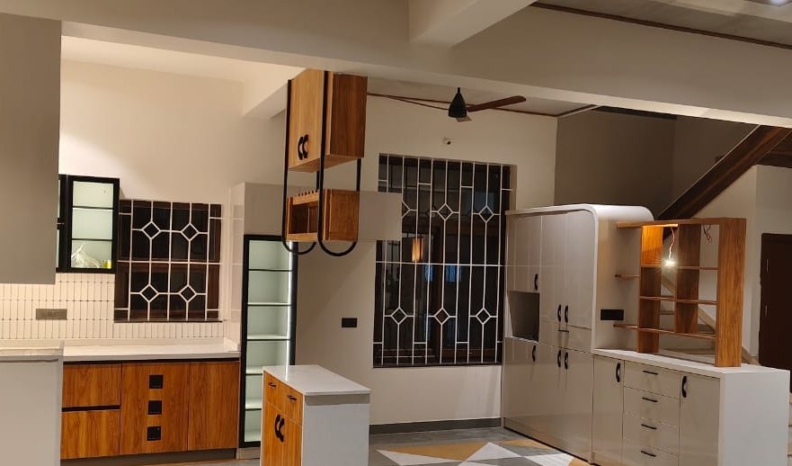 Modular kitchen with an island and fitted carpentry, built by Padmodya Interiors