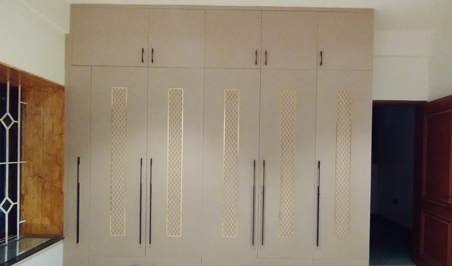 Fitted wardrobe wall in a calm, naturally lit Bangalore bedroom